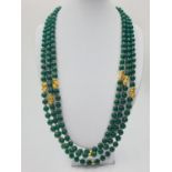 A three row, Chinese necklace, faceted, dark green, jade with gold filled PIXIUs. Length: 61 ? 67cm.