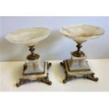 A pair of ornate onyx display plinths, 19cm tall and 3540g weight, a few marks from wear (AF)