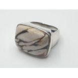 Silver ring having a large cream and brown zebra Jasper stone in rectangular form to top. Clear