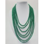 A seven row faceted emerald necklace. Emerald is heat treated and colour enhanced. Length: 43 -64cm.