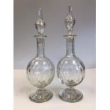 A pair of Georgian hand blown decanters with their original stoppers. One stopper insert is