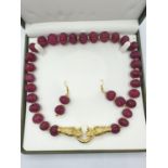 A large beaded, hand carved, gourd shaped, ruby necklace with gold filled dragon heads clasp and