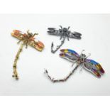 Three large dragonfly brooches in a wooden box. Enamel applied by hand on various metals with