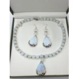 A moonstone necklace and earrings set in a presentation box. Necklace length: 49cm, earrings length: