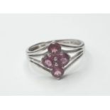 Silver ring having 4 faceted pink 'sapphire' coloured stones to top. Attractive silver strand work