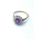 9ct gold ring having a large oval faceted amethyst to mount with a full zirconia surround. Clear