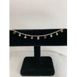 Silver Stones Set Bracelet. The Stones having the colour of Garnet, Amethyst, Peridot, Blue and