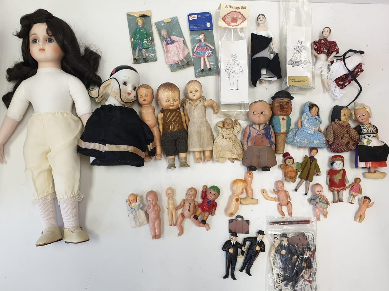 A Large Quantity of Small Vintage Dolls Inc: Porcelain, Plastic, Etc.