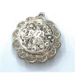 Vintage silver filigree locket in circular cage form, having hinged opening to front with the word