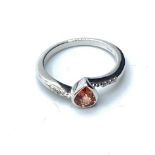 9ct white gold RING with red pear shaped stone. 2.8g Size N