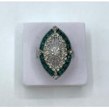An Art Deco silver (stamped 925) ring with green and white gems. Ring size: N
