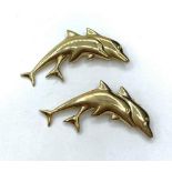 A pair of 9ct dolphin brooches