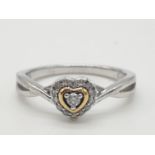 Silver ring with gold and diamond mount in heart form, having twisted silver shoulder detail and