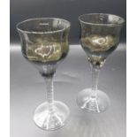 A pair of Smoked twist stem GLASSES. Height 13.5 cm
