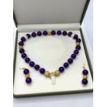 A Chinese dark lavender jade necklace and earrings set in a presentation box. Gold filled spacer