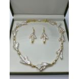 A very unusual Keshi pearls necklace and earrings set in the shape of bird?s feet. In a presentation