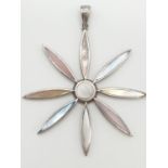 Large silver pendant in flower form having inset mother of pearl in various shades, 6.5cm diameter