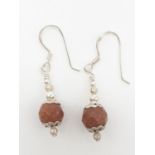 Pair of silver drop earrings having graduated silver ball finished with large bronze faceted ball