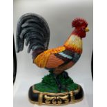 A colourful cast iron cockerel Height: 34 cm, width: 28cm, weight: 3.4 kg.