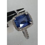 9k white gold with diamonds and blue stone as a centre stone; weight 2.2g & size L