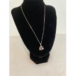 Silver stone set pendant and chain. Pendant having dark pink tourmaline stones interspaced with
