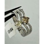 18k white gold ring with diamonds- 2 centre diamonds yellow and brown around 0.59cts and white