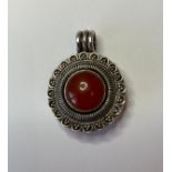 Silver Pill Box Pendant in Circular Form. Dark Orange Centre Stone with Intricate Silver work