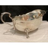 Antique Silver Early 20th Century Sauce Boat. Having scalloped edge and scroll handle. Standing on 3