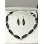 A necklace and earrings set consisting of a dozen Tibetan zee beads, in a presentation box. Tibetans