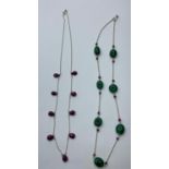 A collection of two chain necklace oval emerald with rubies and ruby drop chain necklace, both