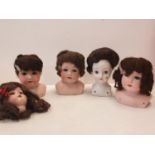 Five Bisque Porcelain Dolls Heads 4 of which have Embossed German Marks.