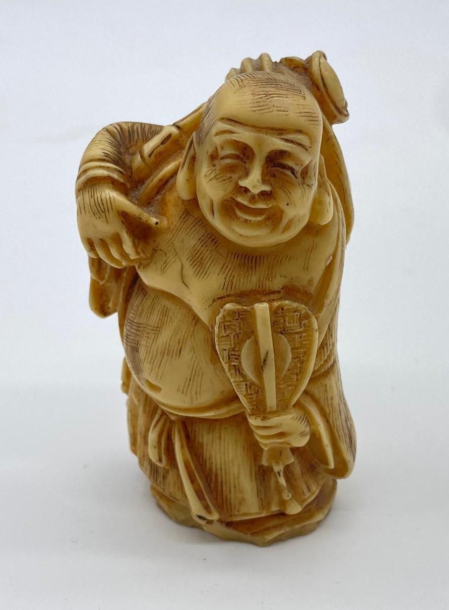 Ivory CHINESE Budha hand carved with fan. 8cm tall. circa 1880.