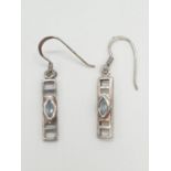 Pair of silver stone set DROP EARRINGS in Art Deco form. Having pale blue topaz coloured stones to