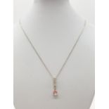 Silver chain and pendant stone set, pendant having clear stone strip leading to pink faceted pear