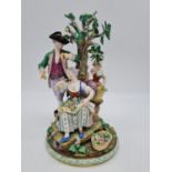 Meissen statue of young family in garden. 26cm tall, width 19cm.