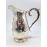 A Silver Water Jug with Ornate Handle. 20cm Height. Weight: 0.65kg
