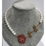 Freshwater pearls necklace set in rubies, emeralds and gold plated silver clasp; around 19inches