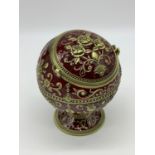 A very ornamental, global, bronze and dark red enamel, ashtray on a circular base. Height: 12cm,