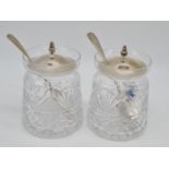 Pair of cut glass silver lidded condiment jars with silver lid and silver spoon. 10cm high 483gm