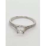 18CT WHITE GOLD EMERALD CUT SOLITAIRE DIAMOND RING WITH DIAMOND SET SHOULDERS, Approx 0.39CT