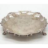 Early English silver tray with 3 legs scallop edge and central armorial crest, 15.5cm diameter