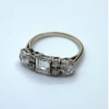 White Gold ring 18 ct having a Quality emerald cut 0.50ct centre diamond flanked by 2x 0.50ct old