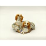 Two dogs in a basket by Dresden, 10cm wide.