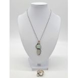 Stone set pendant on chain with matching ring set in silver, total weight 23.81g, pendant 5.5 x