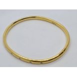 18ct gold bangle with six small diamonds in a Cartier style weighs 28gm.