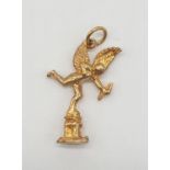 Yellow metal charm/pendant of cupid, weight 1.6g and 25mm long approx