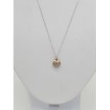 18ct gold diamond set heart shaped pendant set on 46cm long 9ct gold chain, weight 1.87g approx