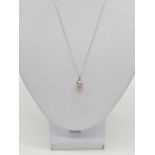 18ct white gold CZ stone pendant set on a 46cm long 9ct gold chain, weight 1.9g and pendant is