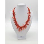 Vintage coral necklace set in yellow metal clasp, weight 27.84g and 46cm long, coral drop at 3cm