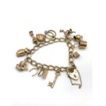 9ct Gold Charm Bracelet with 12 charms and Heart padlock 28.4g and 16cm length